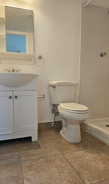 A white toilet sits in a bathroom next to a sink and a bathtub.