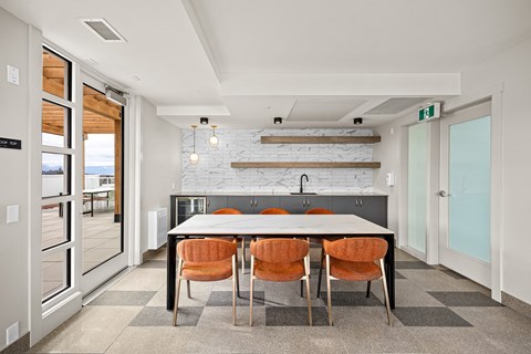 A modern kitchen with a table and chairs.