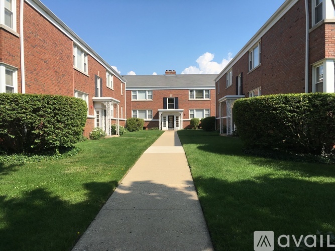 A long pathway leads to a building entrance.