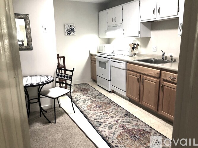 A kitchen with a white dishwasher and a sink.