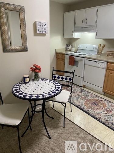 A small dining room with a round table and chairs.