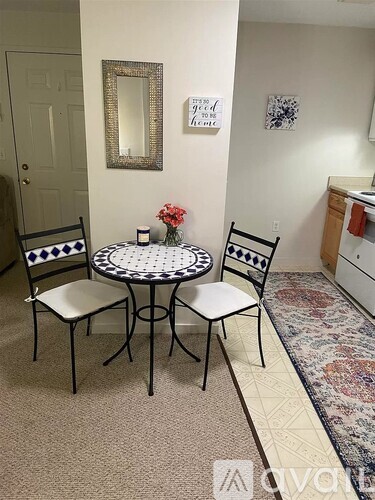 A dining room with a round table and chairs.