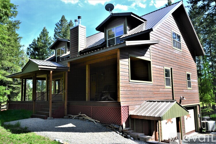 A wooden house with a balcony and a chimney.