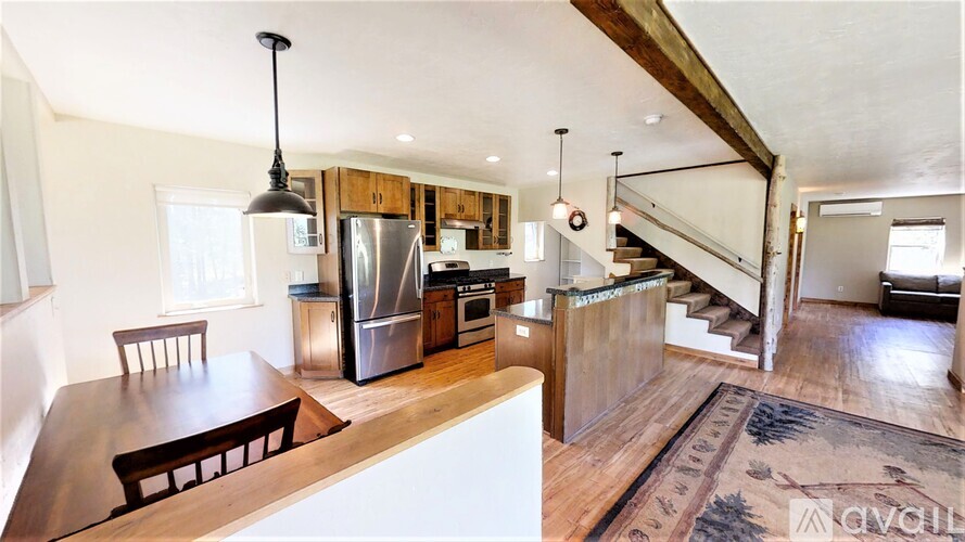 A kitchen with a wooden table and chairs is shown.
