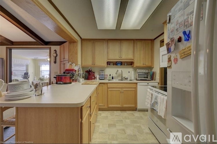 A kitchen with wooden cabinets and a white countertop.