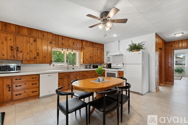 A kitchen with wooden cabinets and a white refrigerator.
