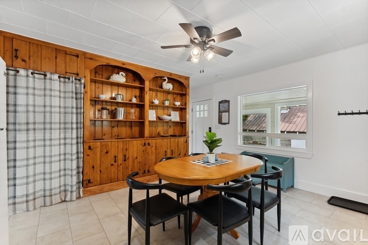A dining area with a wooden table and chairs.