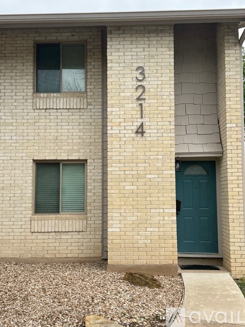 A house numbered 3214 with a blue door.
