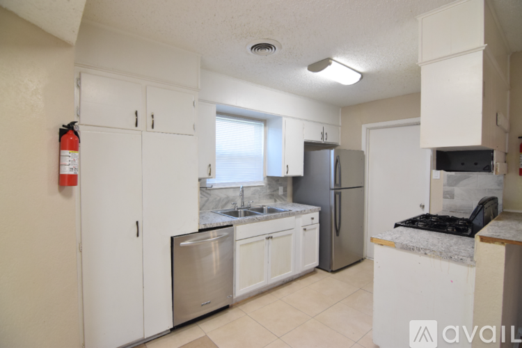 A kitchen with white cabinets and stainless steel appliances.