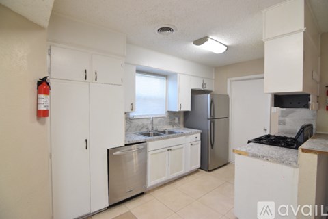 A kitchen with white cabinets and stainless steel appliances.
