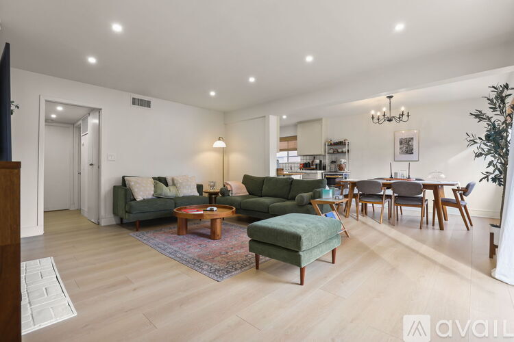 A living room with a green sofa and a wooden coffee table.