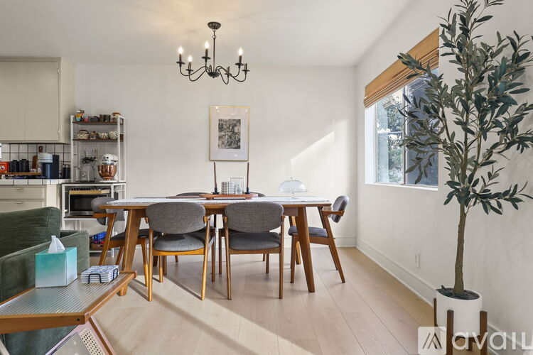 A dining room with a wooden table and chairs.