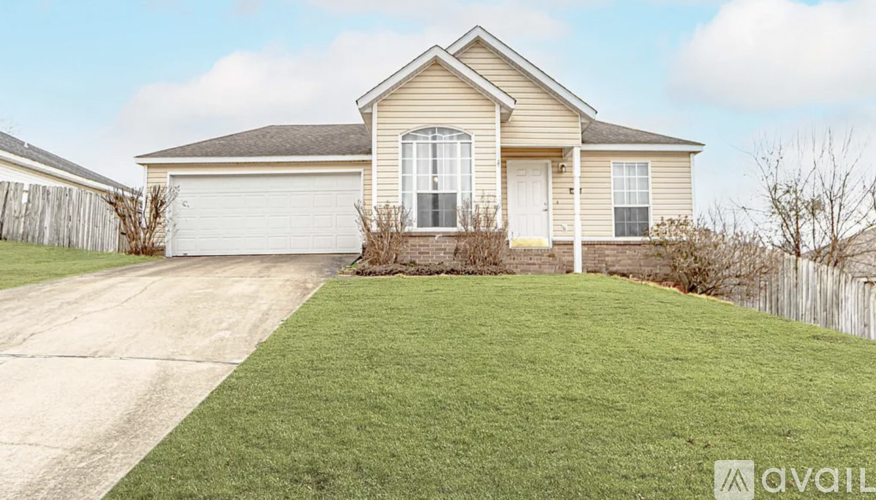 A house with a garage and a driveway in front of it.