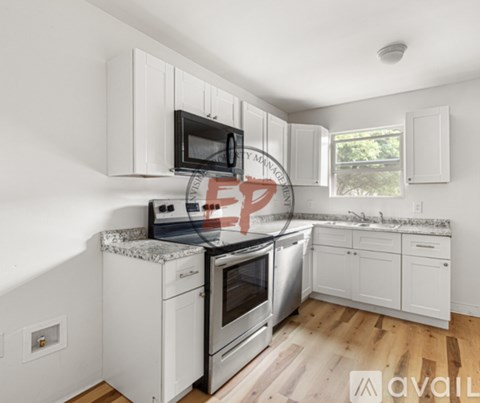 A kitchen with white cabinets and stainless steel appliances.