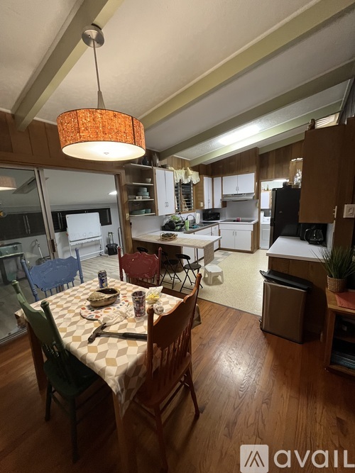 A dining room with a table set for a meal.