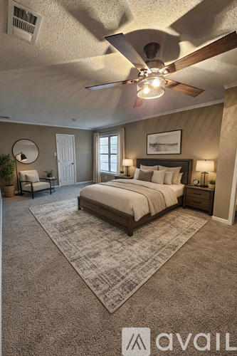 A bedroom with a large bed and a ceiling fan.