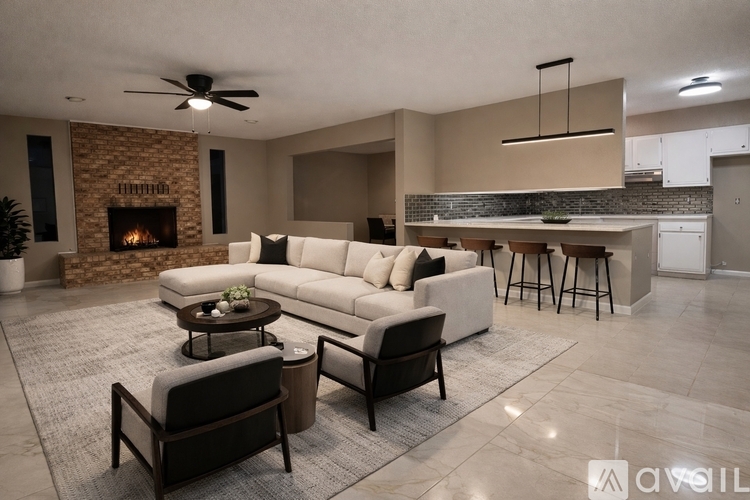 A modern living room with a fireplace and a large couch.