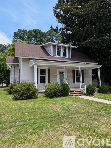 A house with a front porch and a small front yard.