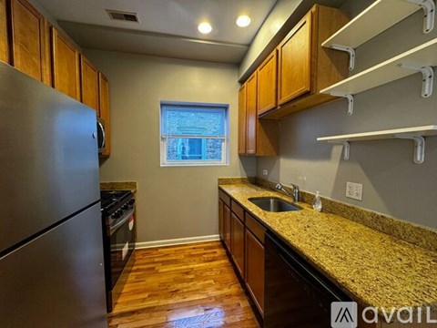 A kitchen with wooden cabinets and a granite countertop.