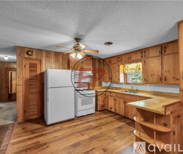 A kitchen with wooden cabinets and a white refrigerator.