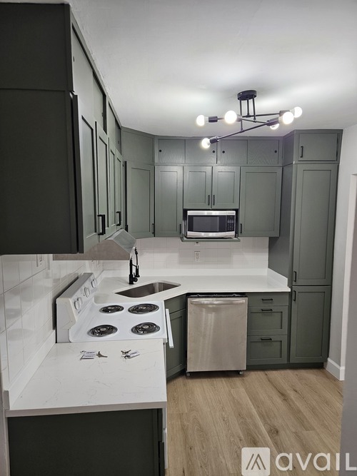 A kitchen with a stove top oven and a microwave.