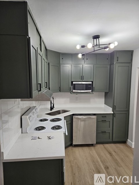 A kitchen with a stove top oven and a microwave.