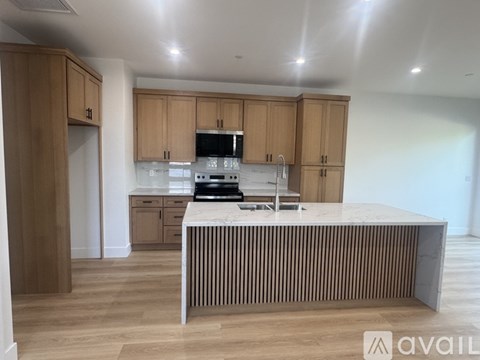 A kitchen with wooden cabinets and a central island.
