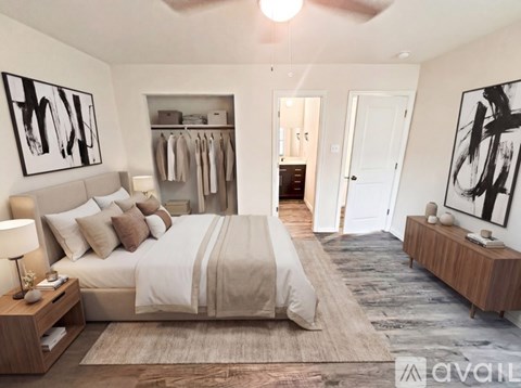 A bedroom with a large bed and a ceiling fan.