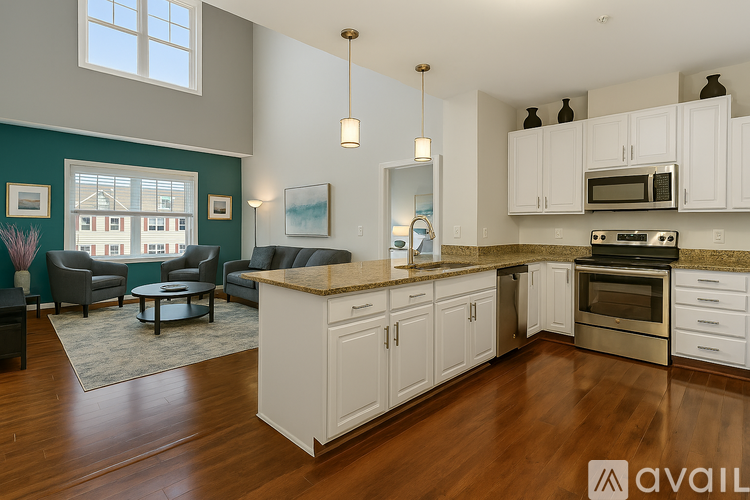 A kitchen with white cabinets and a granite countertop.