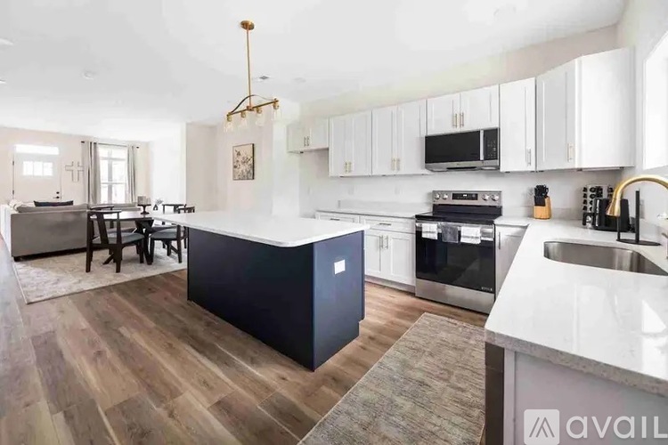 A kitchen with a black island in the middle of the room.
