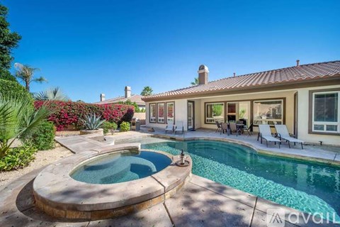 A house with a pool in the backyard.