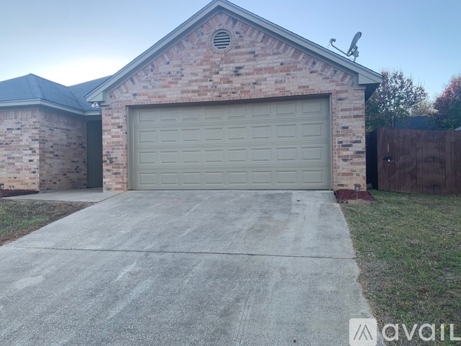 A brick house with a grey garage door.