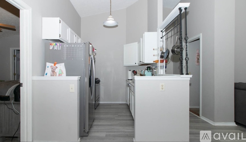 A kitchen with white appliances and cabinets.