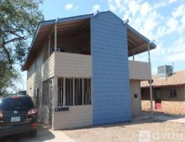 A house under construction with a car parked in front.