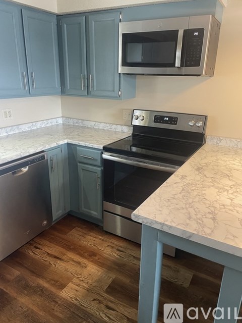 A kitchen with a stove top oven and a microwave above it.