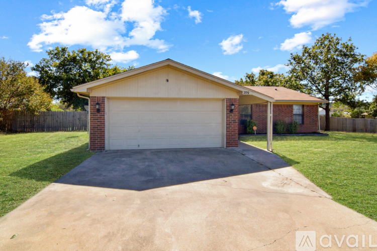 A house with a garage and a driveway in front.