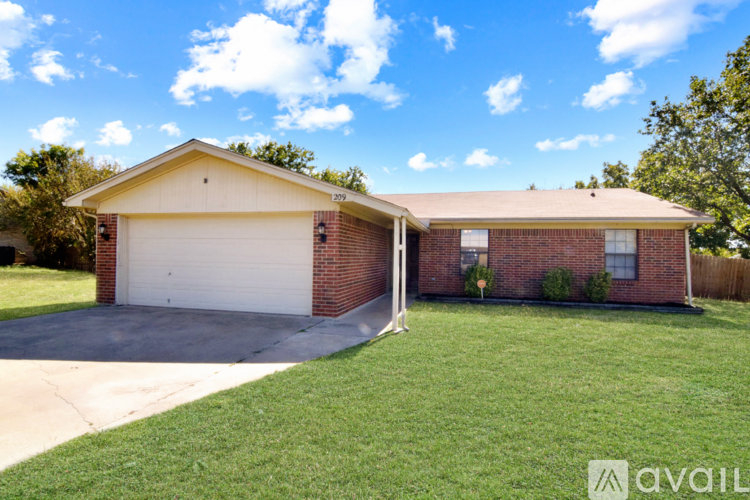 A house with a garage and a driveway is for sale.