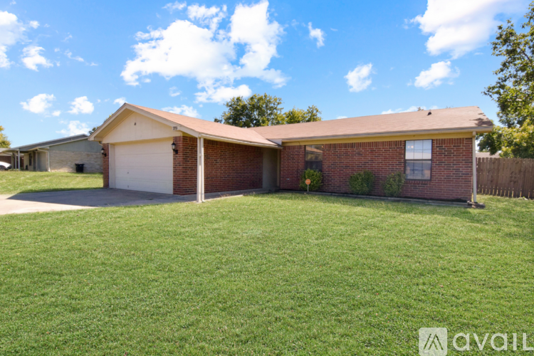 A house with a garage and a driveway is for sale.
