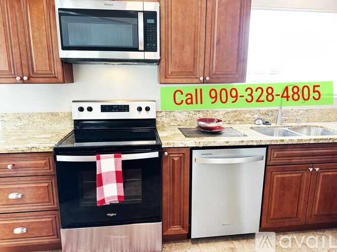 A kitchen with a black oven and a white dishwasher.