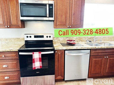 A kitchen with a black oven and a white dishwasher.