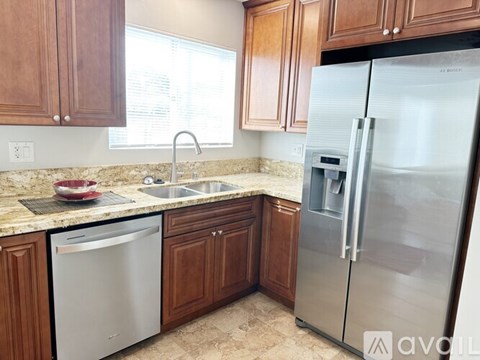 A kitchen with a stainless steel refrigerator and dishwasher.