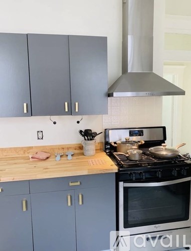 A kitchen with a stove and cabinets.