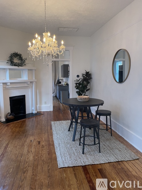 A dining room with a table and chairs.