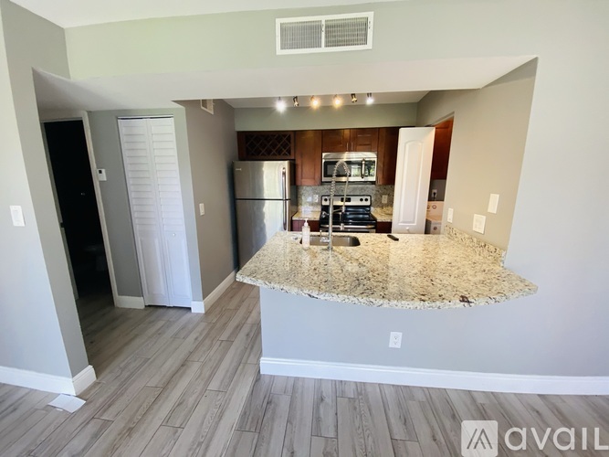 A kitchen with a granite island in the middle of the room.