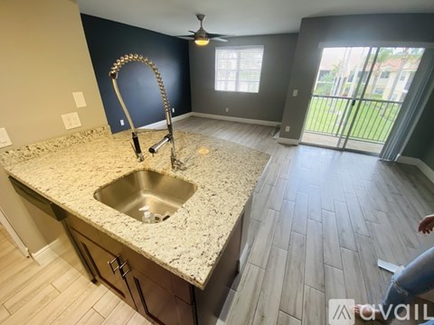A kitchen with a sink and a faucet.