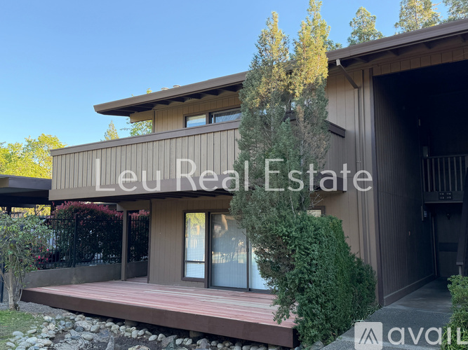 A modern house with the words "Leu Real Estate" on the front.