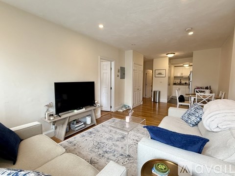 A living room with a television and a couch.