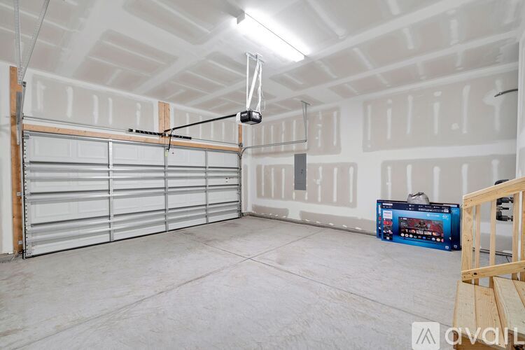 A spacious garage with a ceiling fan and a toolbox on the floor.