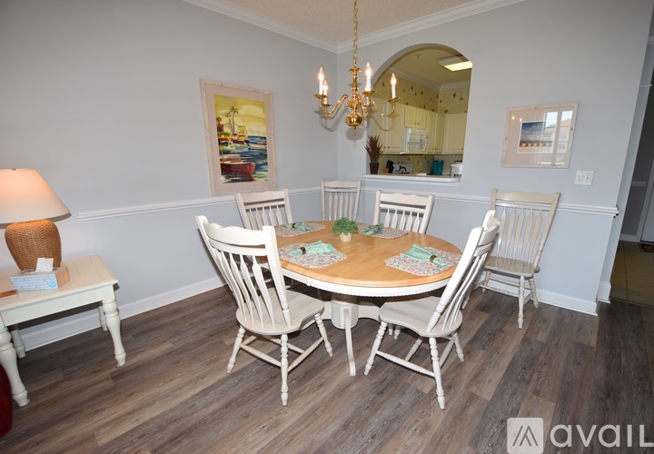 A dining room with a round table and chairs.
