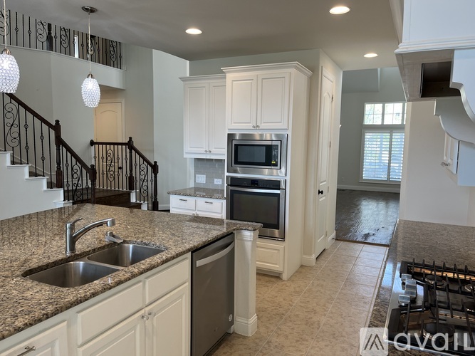 A kitchen with granite countertops and stainless steel appliances.